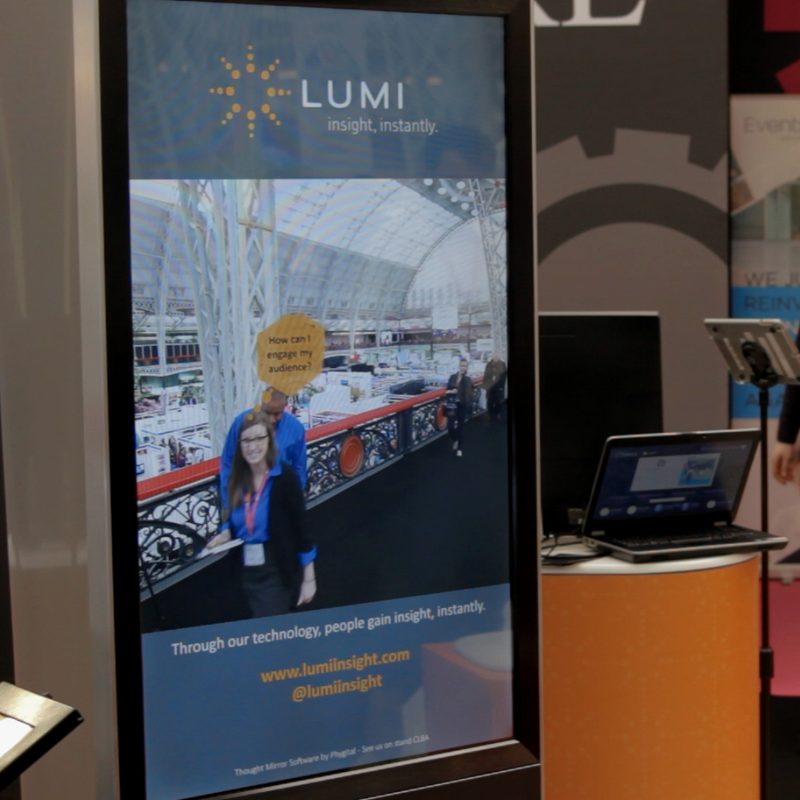 A thought mirror screen showing a guest on a show floor with a thought bubble above her head